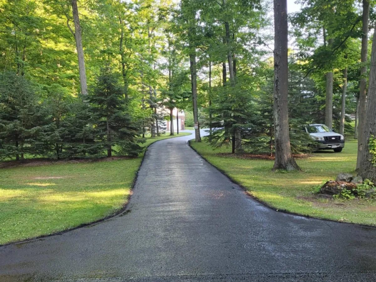 Freshly sealed asphalt driveway with caution tape, Niagara